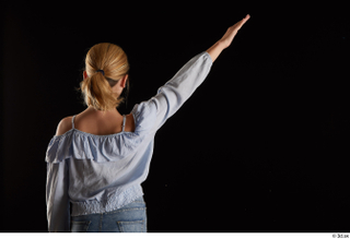 Sarah  1 arm back view blue blouse dressed flexing…